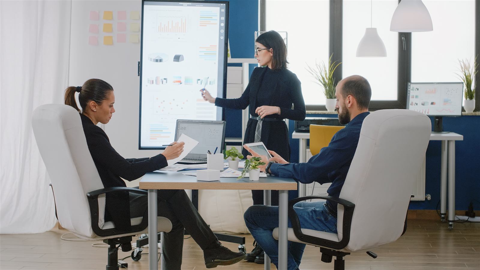 Marketing strategy session — team reviewing campaign performance in a boardroom